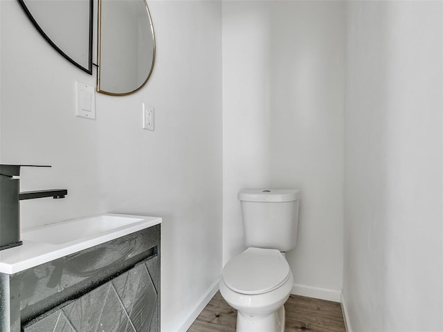 bathroom featuring vanity, toilet, and wood-type flooring