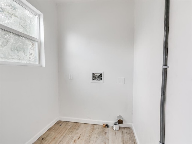 laundry room with light hardwood / wood-style flooring and hookup for a washing machine