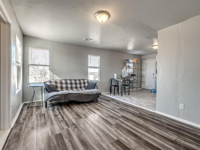 living room featuring a wealth of natural light and wood-type flooring