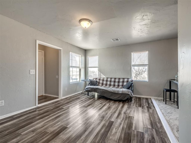 living area with plenty of natural light and wood-type flooring