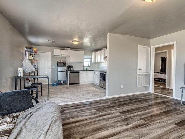 living room featuring sink and hardwood / wood-style floors