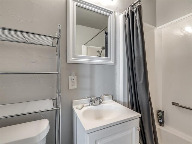 full bathroom with shower / bath combo, toilet, and vanity