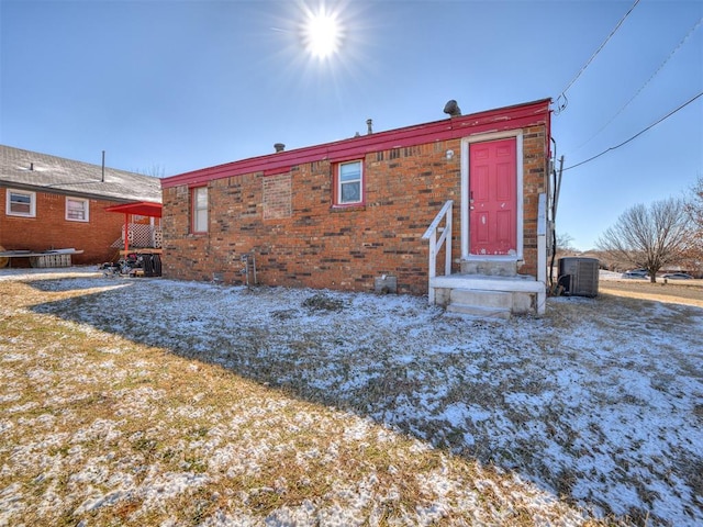 snow covered house with cooling unit