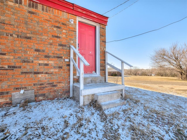 view of snow covered property entrance