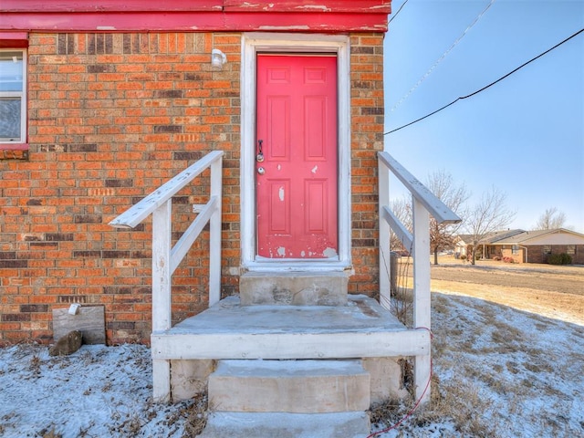 view of snow covered property entrance