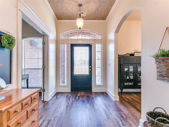 entryway featuring ornamental molding and dark hardwood / wood-style flooring