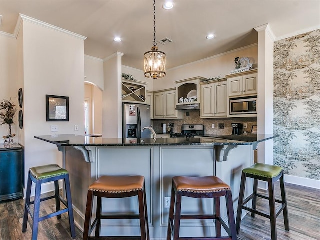 kitchen with hanging light fixtures, stainless steel fridge with ice dispenser, kitchen peninsula, stove, and built in microwave