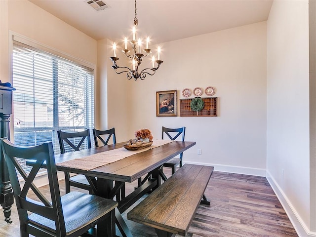 dining area with a chandelier and hardwood / wood-style floors