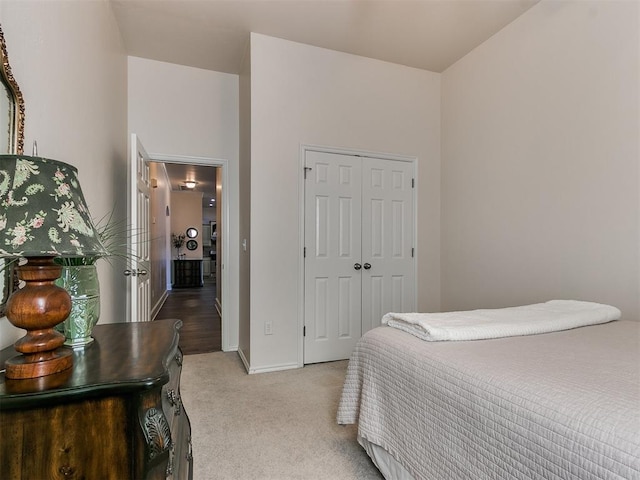 bedroom featuring light colored carpet and a closet