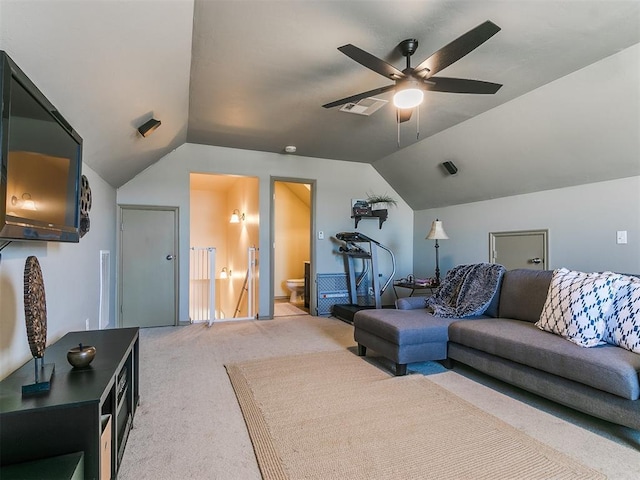 carpeted living room featuring ceiling fan and lofted ceiling