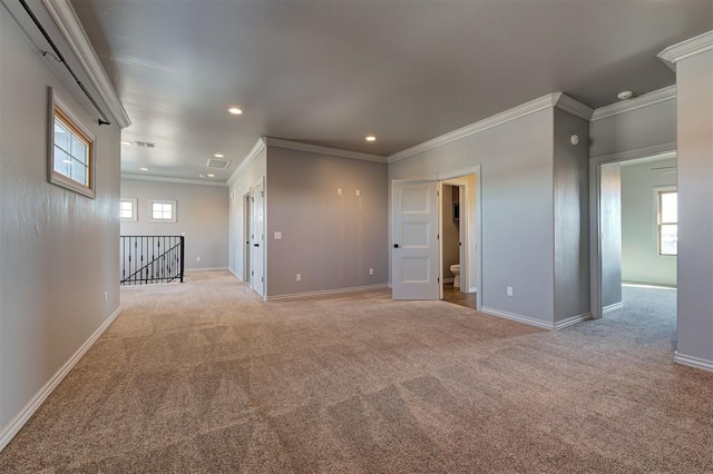 carpeted empty room featuring crown molding