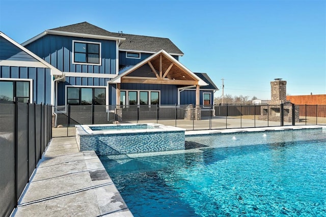 view of pool featuring an in ground hot tub and a patio area