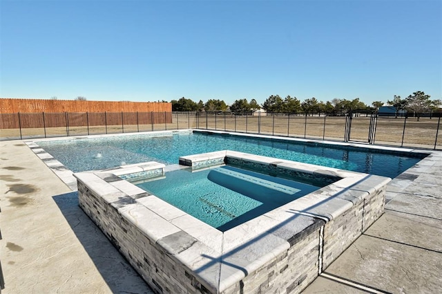 view of pool featuring an in ground hot tub