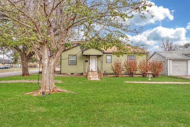 single story home with a garage and a front lawn