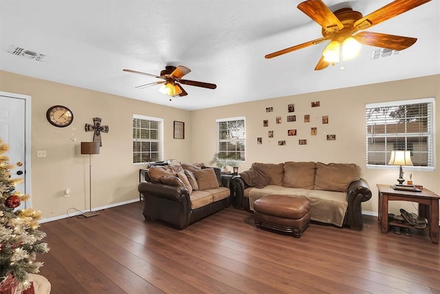 living room with dark wood-type flooring and ceiling fan