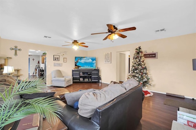 living room with ceiling fan and dark hardwood / wood-style flooring