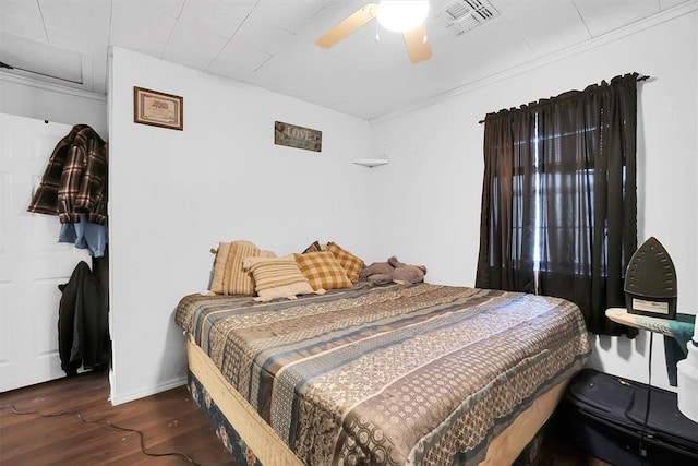 bedroom with ceiling fan and dark hardwood / wood-style flooring