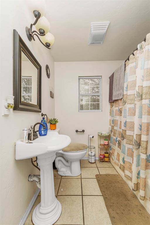 bathroom featuring tile patterned floors and toilet