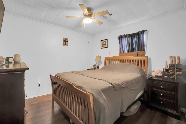 bedroom with ceiling fan, ornamental molding, and dark hardwood / wood-style flooring