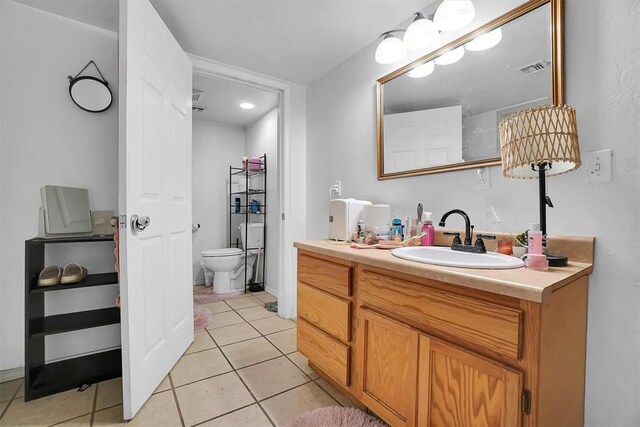 bathroom featuring tile patterned floors, toilet, and vanity