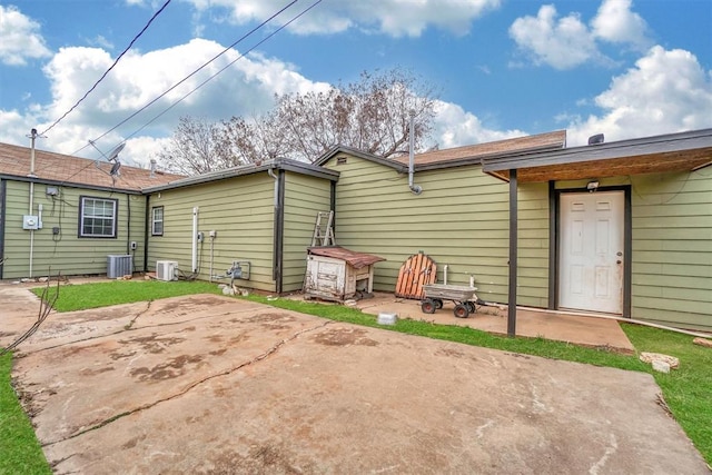 rear view of house featuring a patio and central AC unit