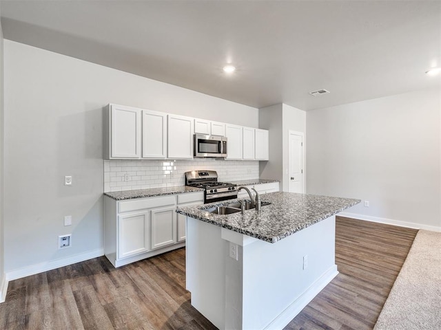 kitchen featuring white cabinetry, appliances with stainless steel finishes, sink, and a center island with sink