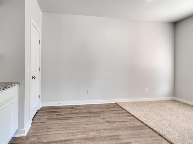 unfurnished room with light wood-type flooring