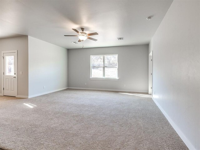 carpeted empty room featuring ceiling fan