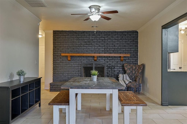 dining space with a brick fireplace, light tile patterned floors, and ornamental molding