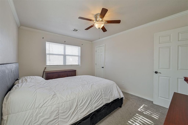 carpeted bedroom with ceiling fan and ornamental molding