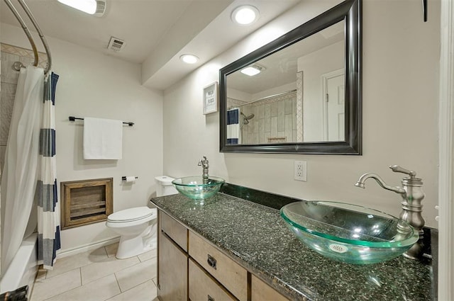 full bathroom featuring tile patterned floors, vanity, toilet, and shower / bath combination with curtain