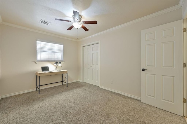 bedroom featuring carpet, ceiling fan, a closet, and ornamental molding