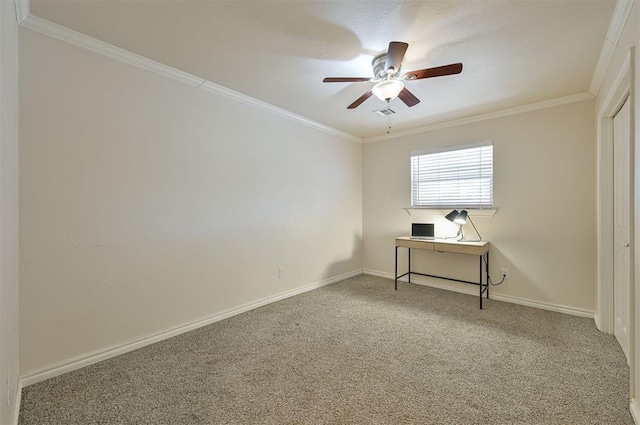 carpeted spare room featuring ceiling fan and crown molding