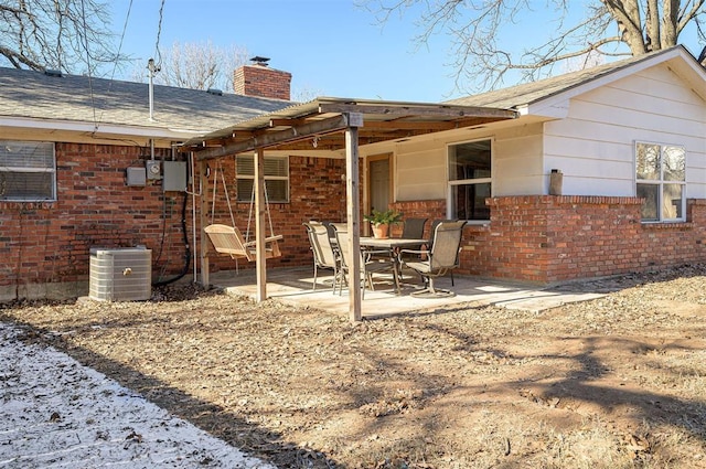 rear view of house featuring central AC and a patio