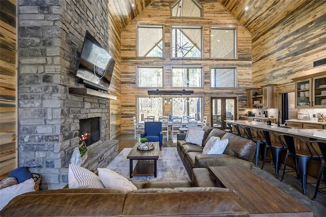 living room with high vaulted ceiling, wooden ceiling, and a fireplace