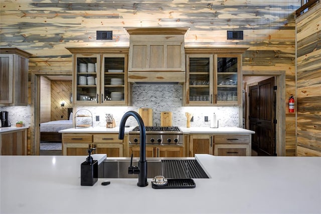 kitchen featuring decorative backsplash and custom range hood