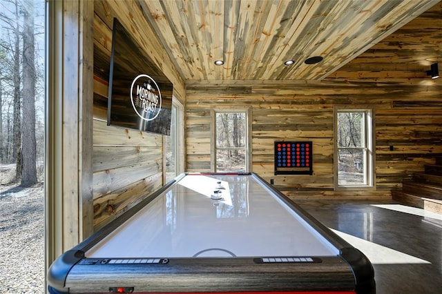 game room with wooden walls, plenty of natural light, and wood ceiling