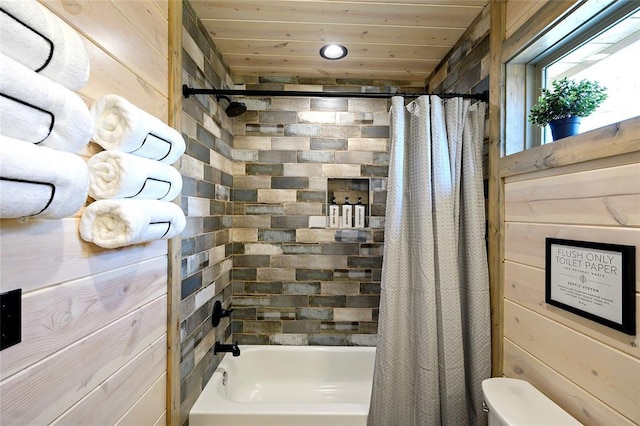 bathroom with wooden walls, wood ceiling, toilet, and shower / tub combo