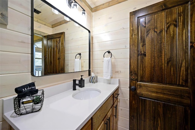 bathroom with wooden walls and vanity