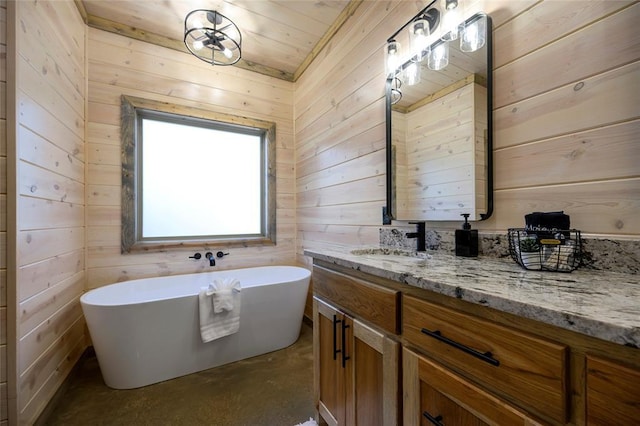 bathroom featuring a washtub, concrete flooring, wooden walls, and vanity