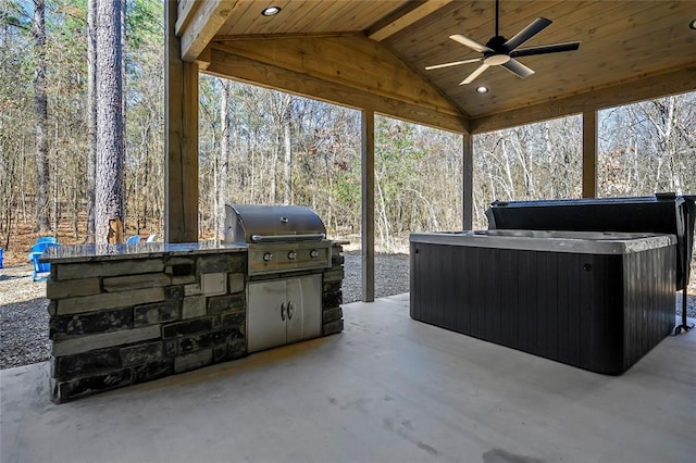 view of patio with a hot tub, exterior kitchen, ceiling fan, and grilling area