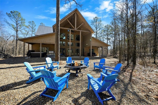 back of house featuring an outdoor fire pit, ceiling fan, and a patio area