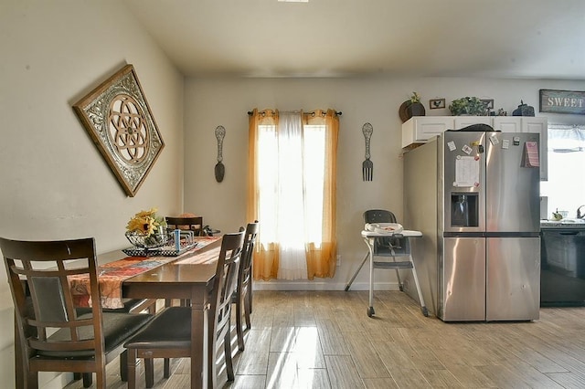 dining space with light hardwood / wood-style flooring