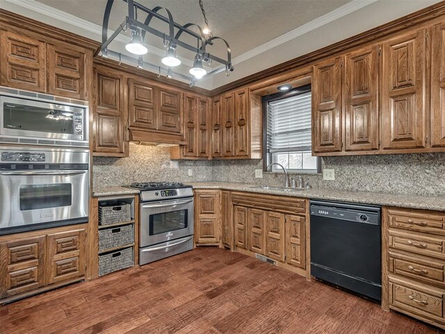 kitchen featuring sink, stainless steel appliances, light stone countertops, dark hardwood / wood-style flooring, and decorative backsplash