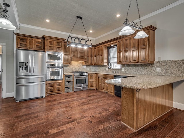 kitchen with appliances with stainless steel finishes, pendant lighting, a breakfast bar area, decorative backsplash, and kitchen peninsula