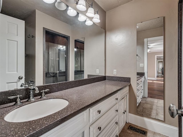 bathroom with vanity, tile patterned floors, and a shower