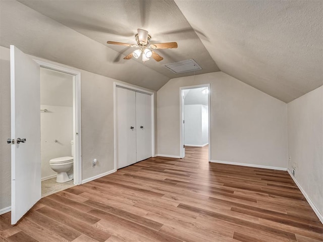 bonus room with vaulted ceiling, ceiling fan, and light hardwood / wood-style floors