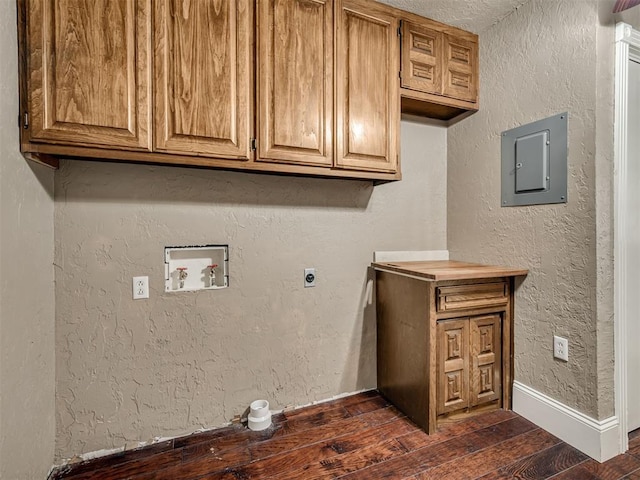 washroom with cabinets, dark hardwood / wood-style floors, electric panel, electric dryer hookup, and washer hookup