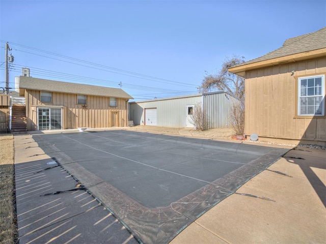 exterior space with a garage and an outdoor structure