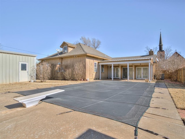 back of property featuring french doors and a patio area